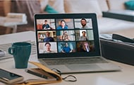 a laptop with a virtual zoom meeting taking place