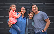 Portait of smiling hispanic family standing