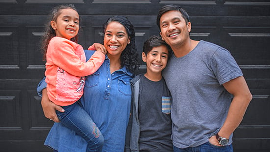 Portait of smiling hispanic family standing